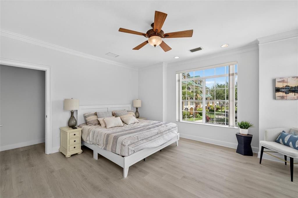 6428 Sunset Bay Circle Apollo Beach, FL 33572 - Photo 34 of 90 a bedroom with a bed and a ceiling fan