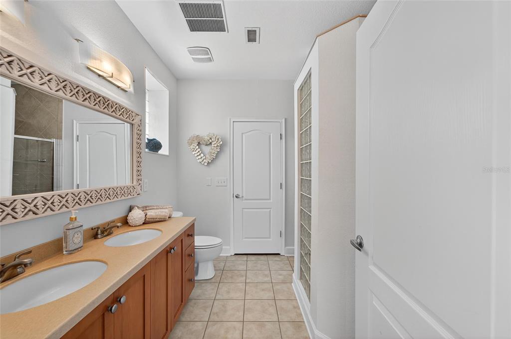 6428 Sunset Bay Circle Apollo Beach, FL 33572 - Photo 36 of 90 a bathroom with a sink a toilet and shower