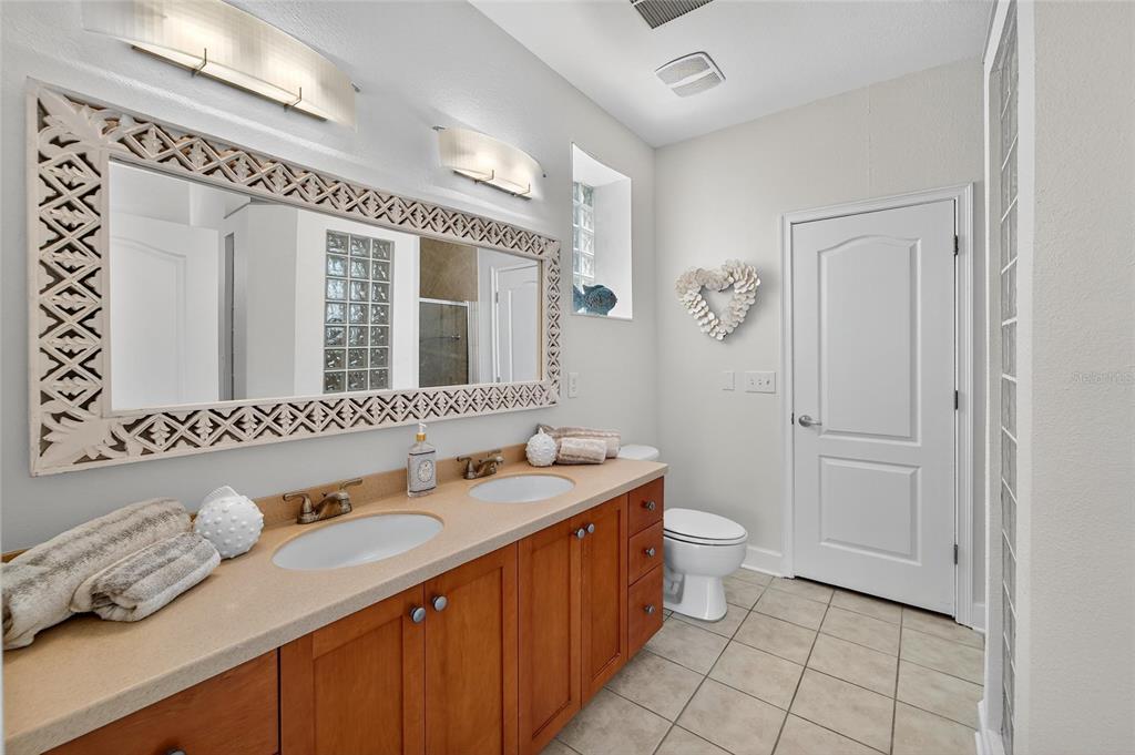6428 Sunset Bay Circle Apollo Beach, FL 33572 - Photo 37 of 90 a bathroom with a granite countertop sink mirror and toilet