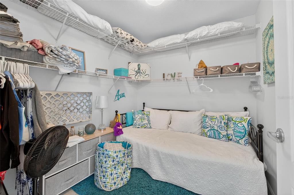 6428 Sunset Bay Circle Apollo Beach, FL 33572 - Photo 49 of 90 a bedroom with a bed and gym equipment