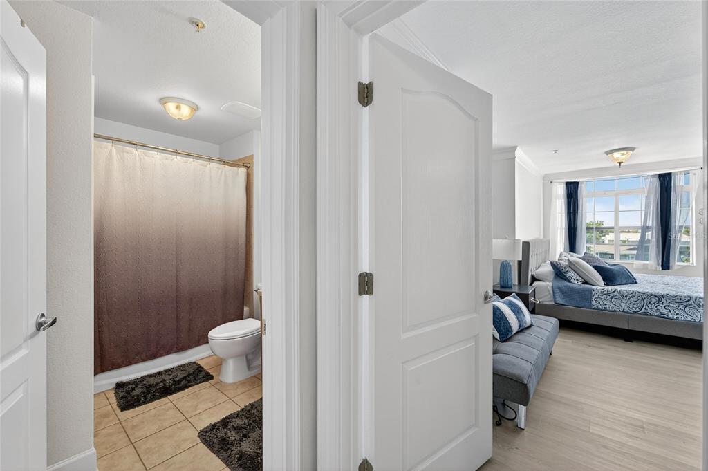 6428 Sunset Bay Circle Apollo Beach, FL 33572 - Photo 50 of 90 a bedroom with a bed and a view of living room