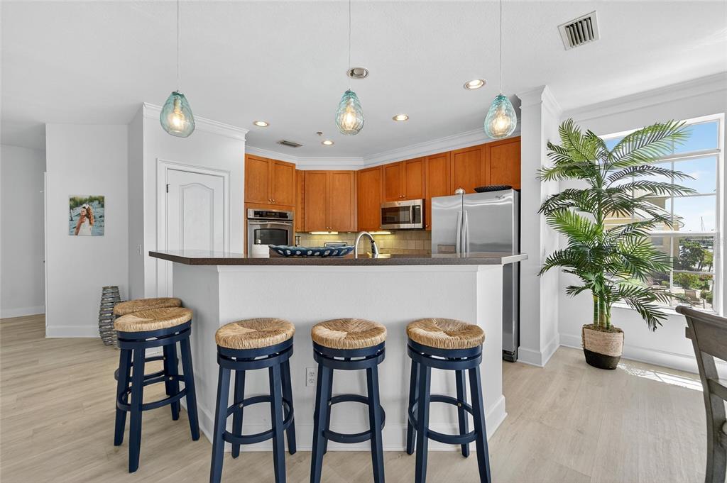 6428 Sunset Bay Circle Apollo Beach, FL 33572 - Photo 6 of 90 a kitchen with a table and chairs in it