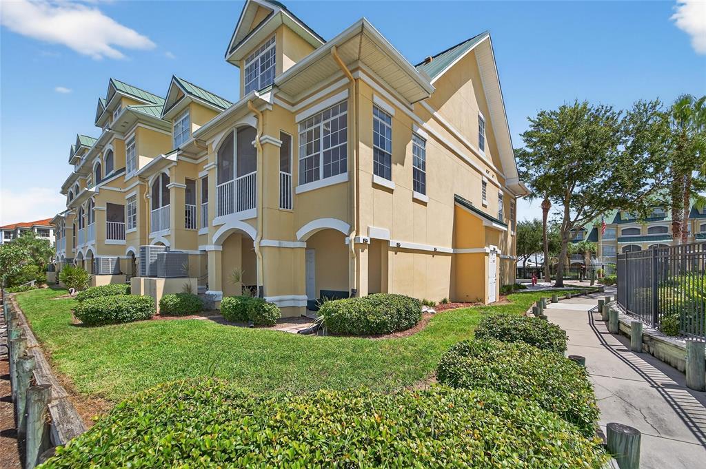 6428 Sunset Bay Circle Apollo Beach, FL 33572 - Photo 61 of 90 a view of a blue and white house with a yard and plants