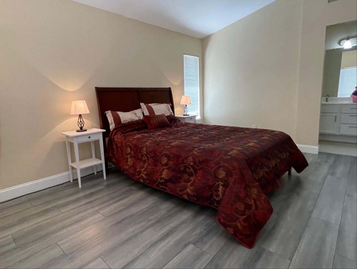445 Powell Drive Bay Point, CA 94565 - Photo 23 of 43 a bedroom with a bed lamp and a fireplace