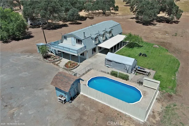an aerial view of a house with outdoor space