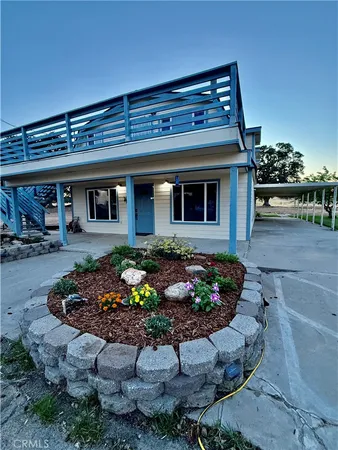 a view of a backyard with plants and patio