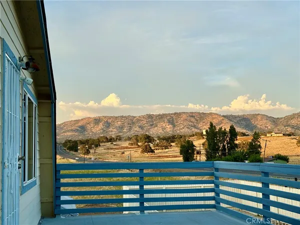 a view of a balcony with two chairs and a table