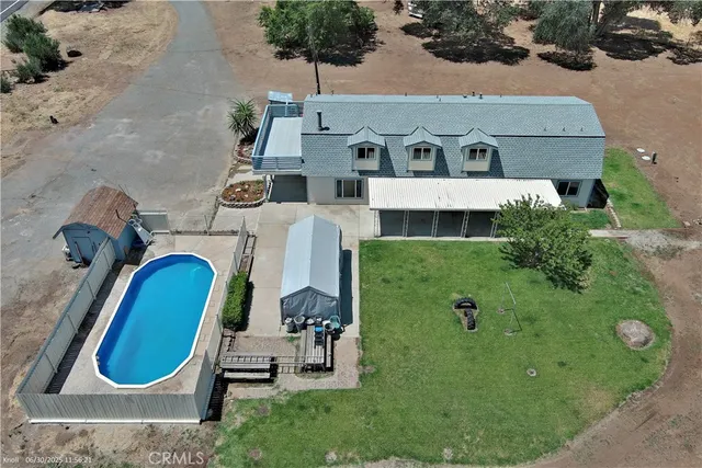 an aerial view of a house with a swimming pool