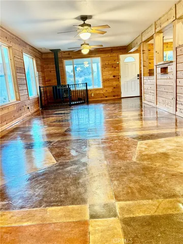 a room with a bed and a large window with outer view