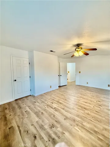a view of a house with a wooden fence
