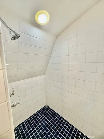 a view of a house with a wooden fence