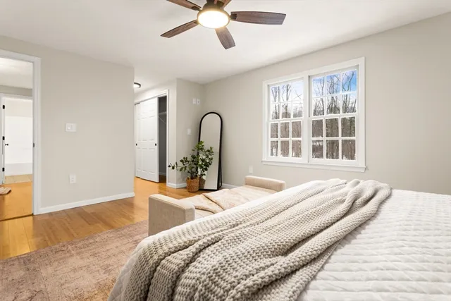 a bedroom with a bed and wooden floor