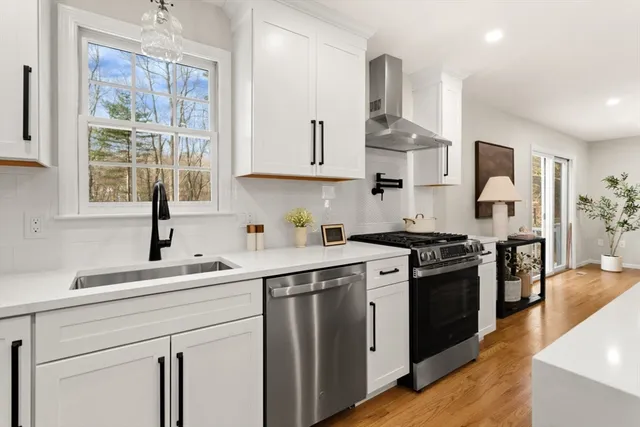 a kitchen with stainless steel appliances a sink stove and cabinets