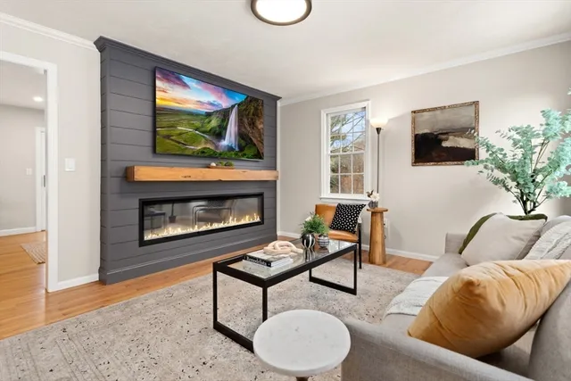 a living room with furniture and a fireplace