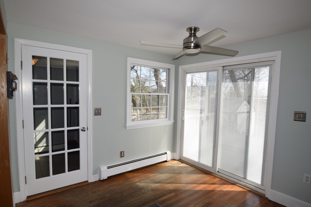 71 Rockefeller Street Randolph, MA 02368 - Photo 6 of 23 a view of an empty room with a window and wooden floor