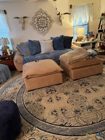a view of entryway with furniture and front door