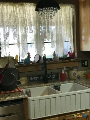 a kitchen sink with a stove and cabinets