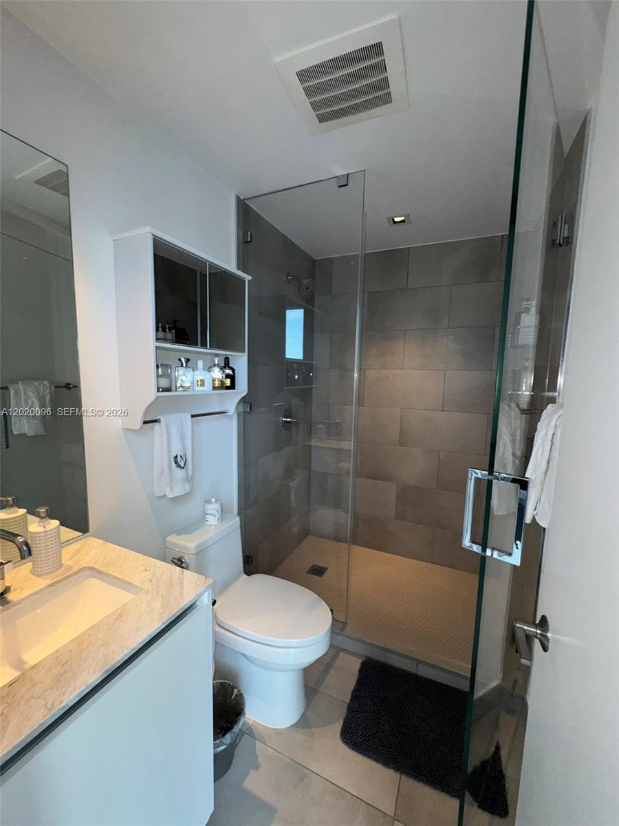 788 Northeast 23rd Street, Unit 1202 Miami, FL 33137 - Photo 31 of 64 a bathroom with a sink toilet vanity and shower