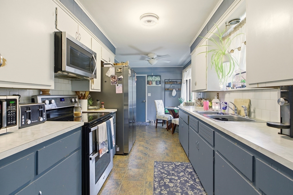 507 R Stafford Road Tiverton, RI 02878 - Photo 11 of 38 a kitchen with stainless steel appliances granite countertop a sink stove and cabinets