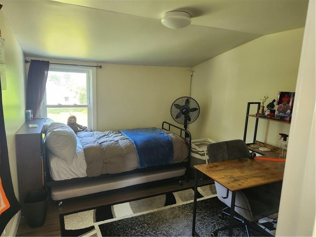 507 R Stafford Road Tiverton, RI 02878 - Photo 30 of 38 a bedroom with a bed and a table in it