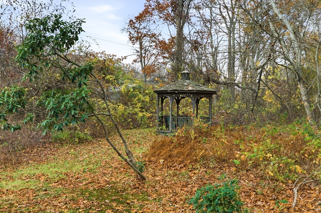 507 R Stafford Road Tiverton, RI 02878 - Photo 33 of 38 a view of a garden with a bench