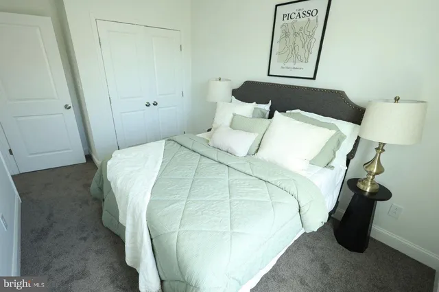 a bedroom with a bed and a mirror