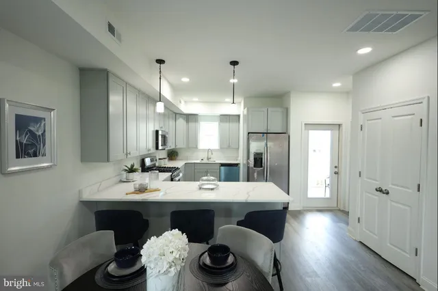 a large kitchen with a table and chairs