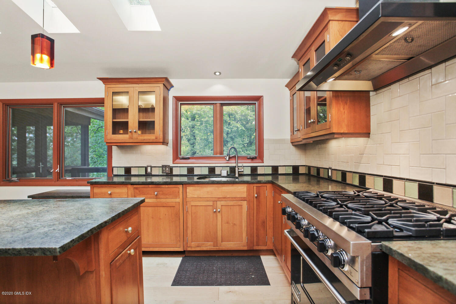 39 Crawford Terrace Riverside, CT 06878 - Photo 16 of 37 a kitchen with granite countertop stainless steel appliances a sink stove and cabinets
