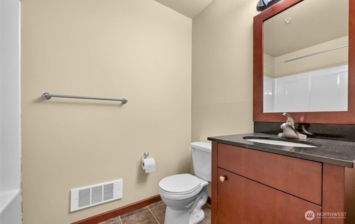259 West Bakerview Road, Unit C102 Bellingham, WA 98226 - Photo 17 of 29 a bathroom with a granite countertop toilet sink and mirror