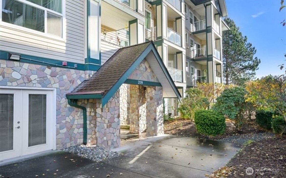 259 West Bakerview Road, Unit C102 Bellingham, WA 98226 - Photo 2 of 29 a front view of a house with garden