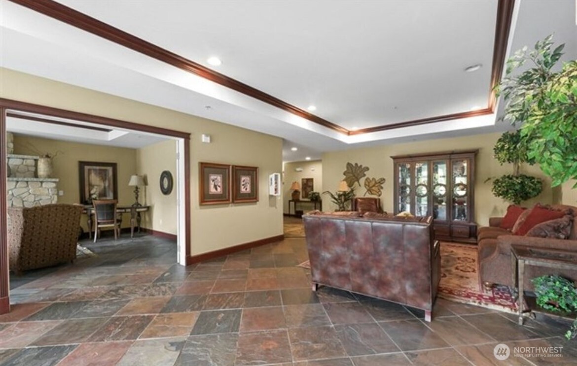 259 West Bakerview Road, Unit C102 Bellingham, WA 98226 - Photo 22 of 29 a living room with couches and potted plants with large windows