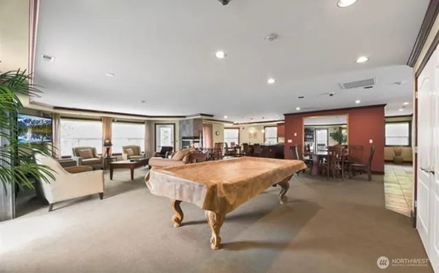 a living room with furniture a table and potted plants