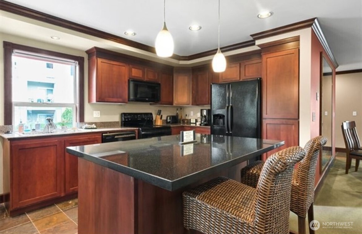 259 West Bakerview Road, Unit C102 Bellingham, WA 98226 - Photo 25 of 29 a kitchen with stainless steel appliances granite countertop a sink refrigerator and a stove