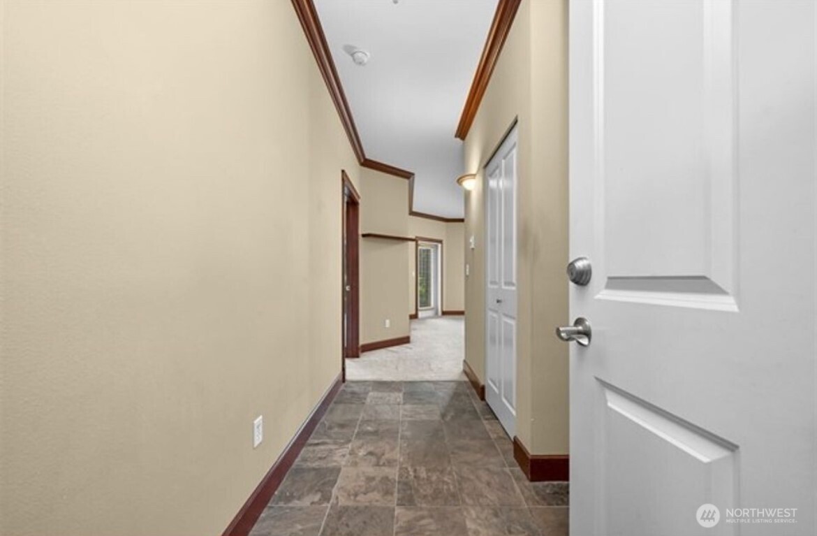 259 West Bakerview Road, Unit C102 Bellingham, WA 98226 - Photo 3 of 29 a view of a hallway with wooden floor and staircase