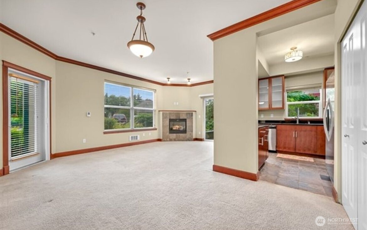 259 West Bakerview Road, Unit C102 Bellingham, WA 98226 - Photo 5 of 29 a view of an empty room with a fireplace and a window