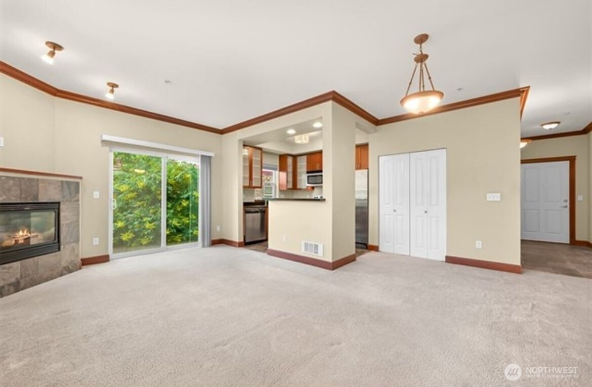 259 West Bakerview Road, Unit C102 Bellingham, WA 98226 - Photo 7 of 29 a view of a kitchen with a sink and a fireplace