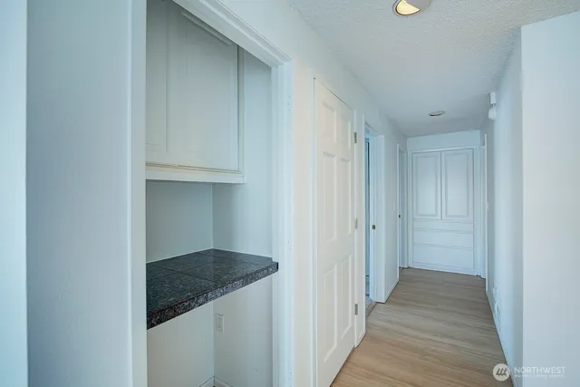 a view of a hallway with wooden floor and staircase