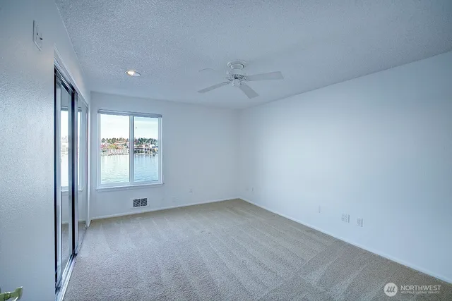 an empty room with a empty space and windows