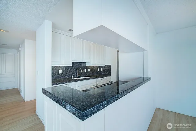 a kitchen with stainless steel appliances granite countertop a sink stove and microwave