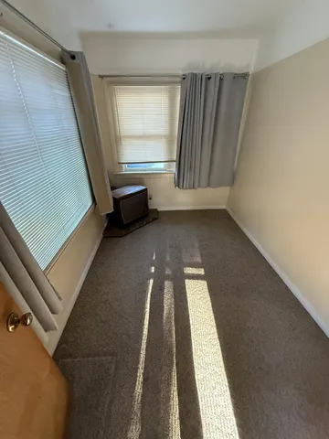 a view of a room with wooden floor and chair