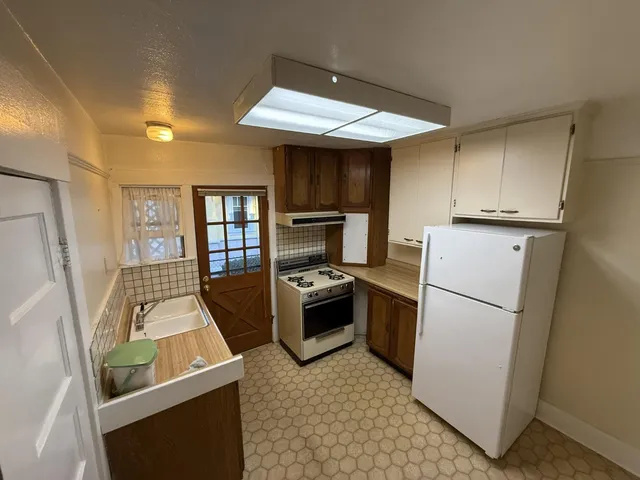 a kitchen with a refrigerator stove and sink
