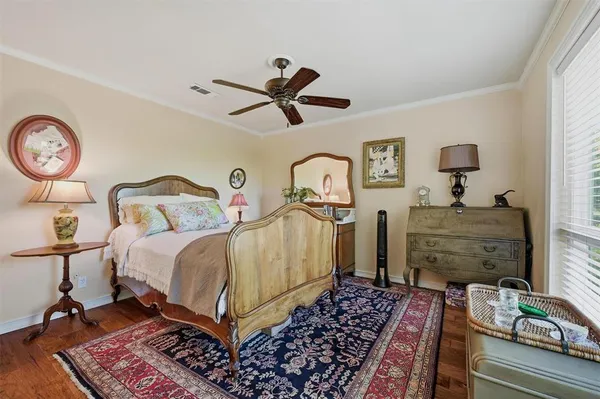 a bedroom with bed and wooden floor