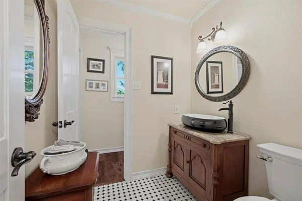 a bathroom with a sink a toilet and mirror