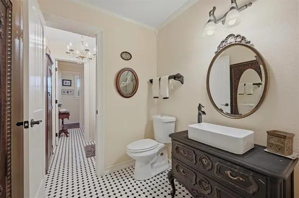 a bathroom with a toilet a sink and a mirror