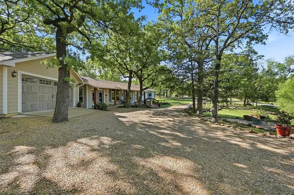a view of a house with a tree in front of it