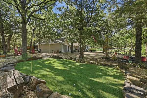 a backyard of a house with table and chairs