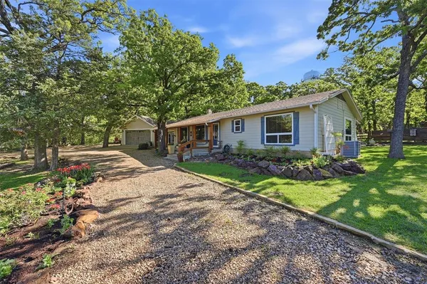 a view of backyard of house with green space