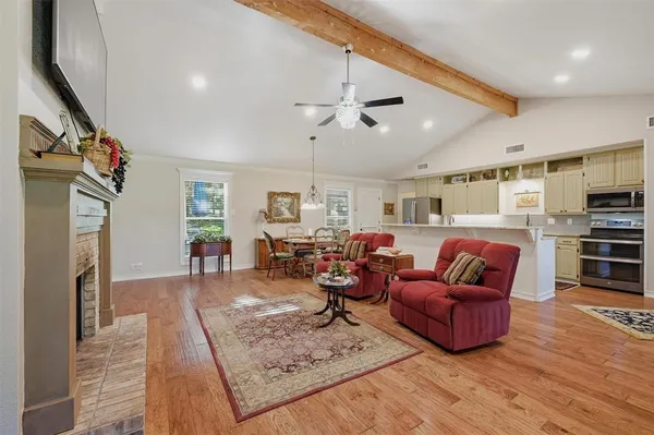 a living room with furniture a fireplace and a flat screen tv