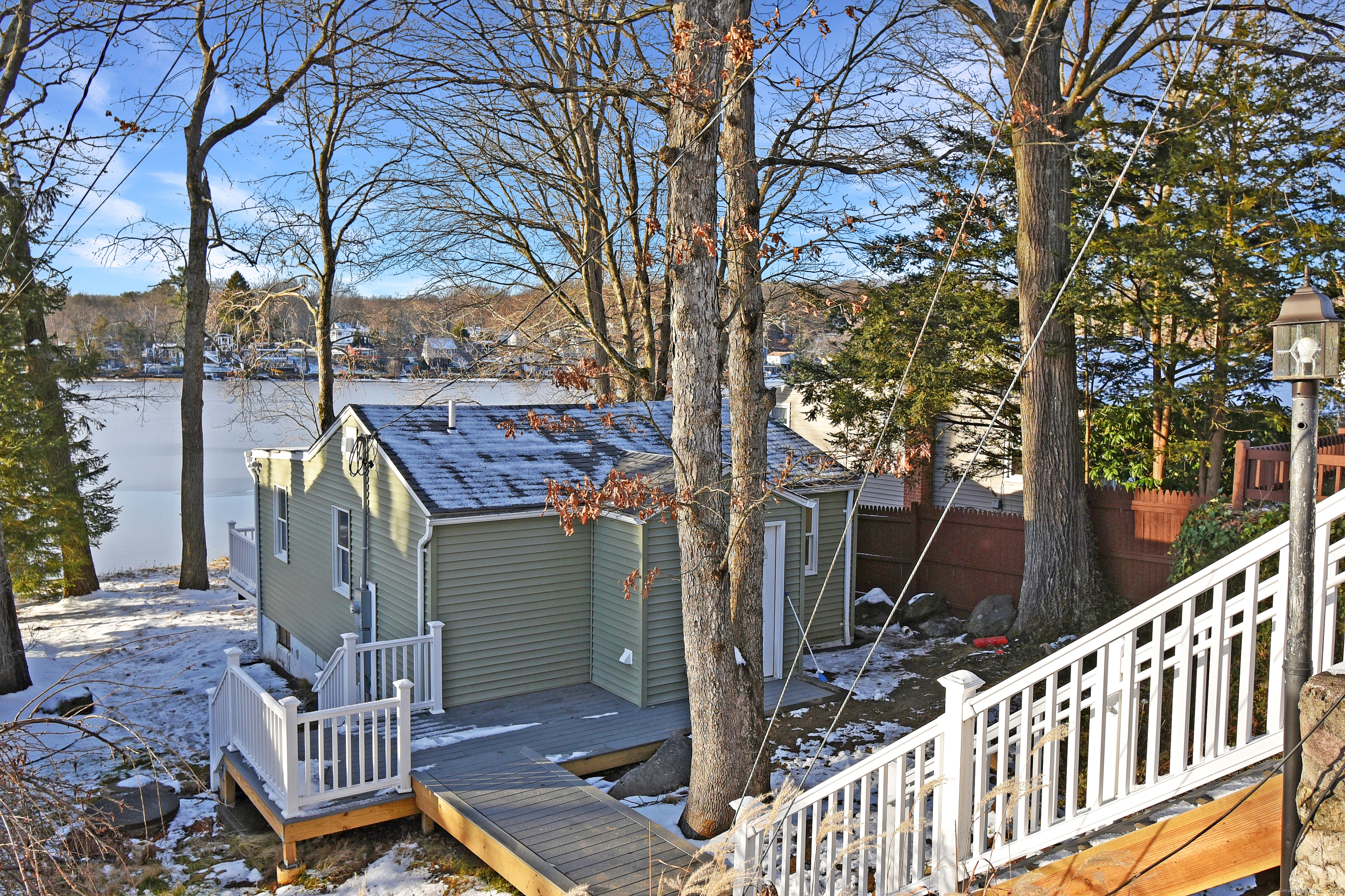 a view of a deck with wooden floor and fence