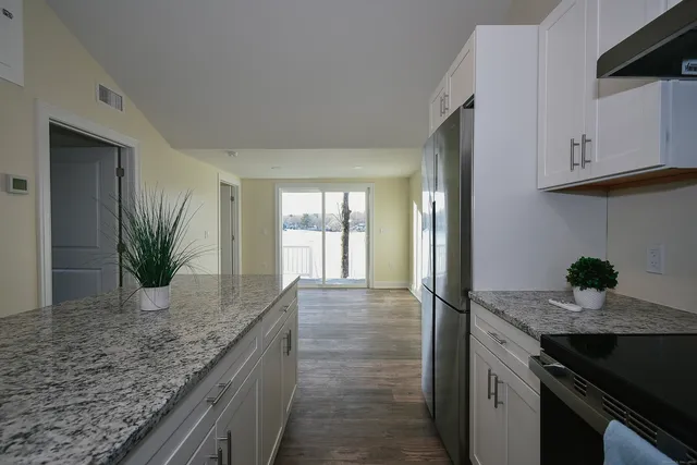 a kitchen with granite countertop a sink and a stove